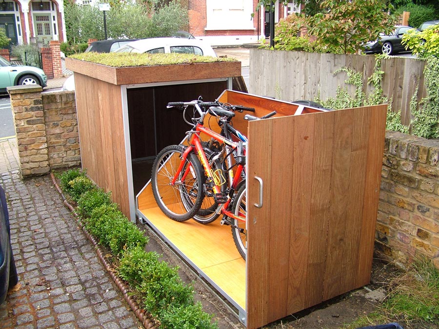 Wooden box, showing two bikes placed on a rack.